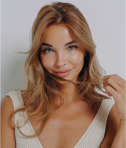 Smiling woman with flowing hair and natural makeup