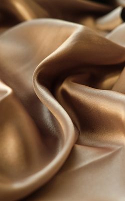 Glossy brown satin fabric draped elegantly.