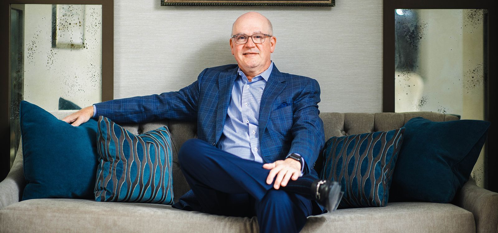 Surgeon smiling in an operating room setting.