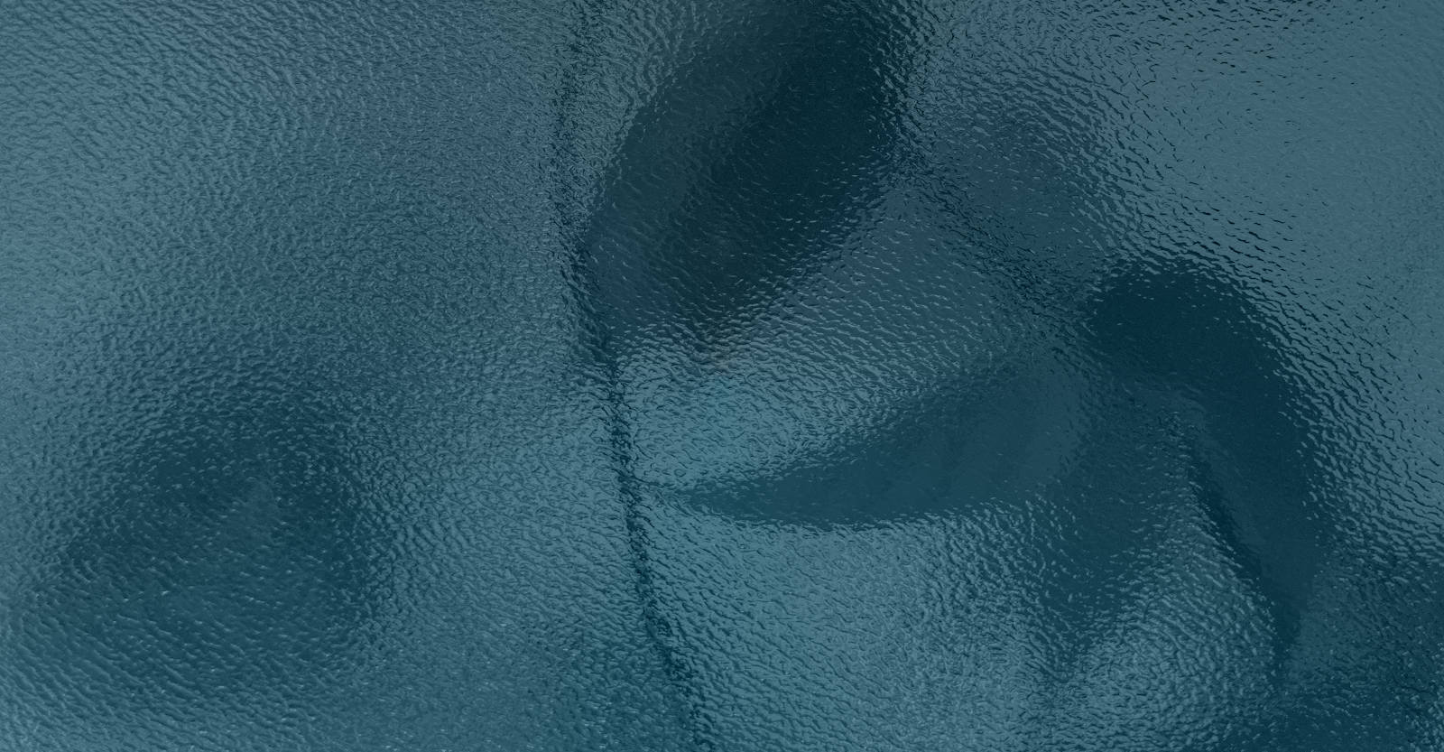 Textured blue glass surface with rippled pattern.