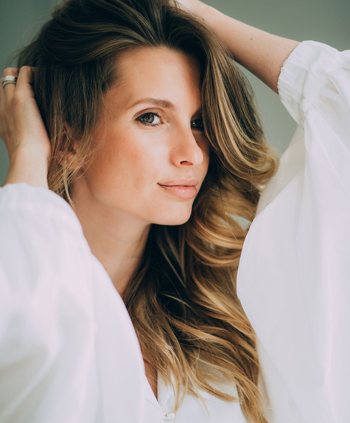 Woman with long hair in a white blouse.