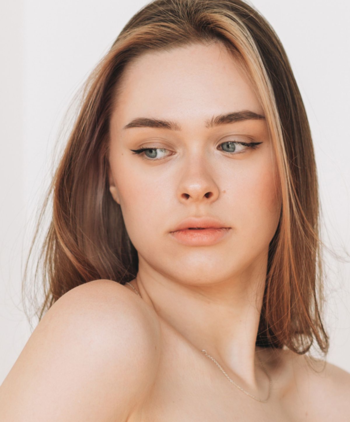 Woman with long hair looking over her shoulder.