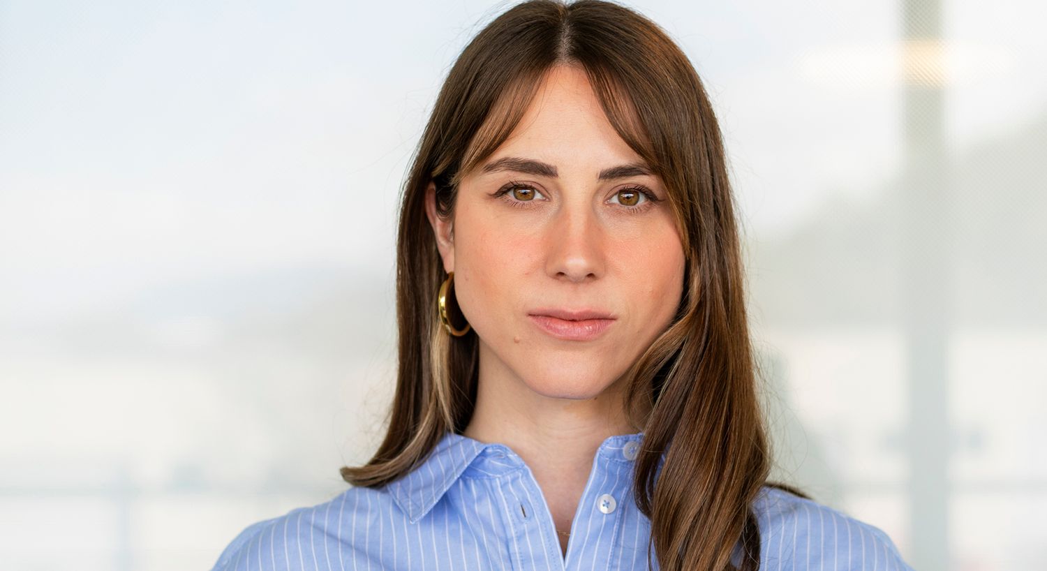 Woman with long hair in blue shirt.